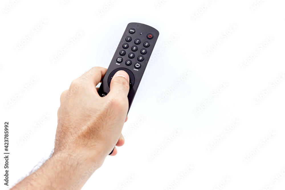 Man holding a black tv remote control isolated on a white background Man holding a black tv remote control isolated on a white background