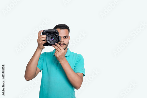 man with a professional DSLR camera, showing thumbs up, checking photos, showing the camera, operating the camera, with a blank white plate
