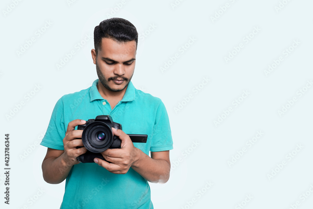 man with a professional DSLR camera, showing thumbs up, checking photos, showing the camera, operating the camera, with a blank white plate man with a professional DSLR camera, showing thumbs up, checking photos, showing the camera, operating the camera, with a blank white plate