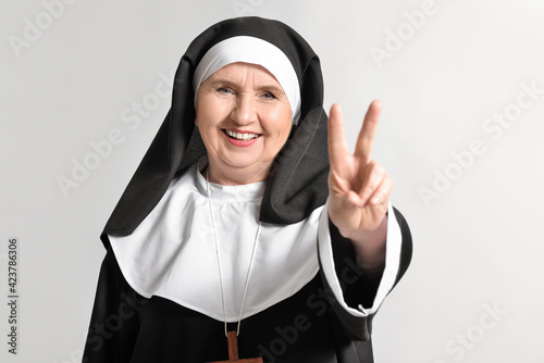 Senior nun showing victory ...