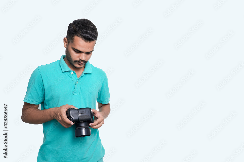 man with a professional DSLR camera, showing thumbs up, checking photos, showing the camera, operating the camera, with a blank white plate man with a professional DSLR camera, showing thumbs up, checking photos, showing the camera, operating the camera, with a blank white plate