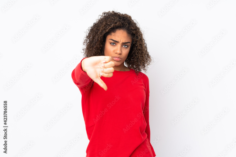 Young African American woman isolated on background showing thumb down with negative expression Young African American woman isolated on background showing thumb down with negative expression