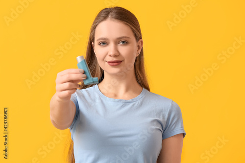 Young woman with inhaler on...