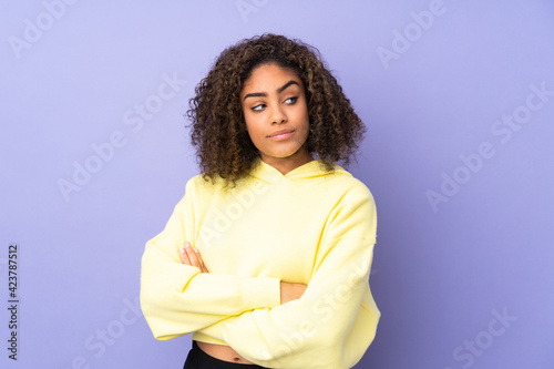 Young African American woman isolated on background keeping the arms crossed