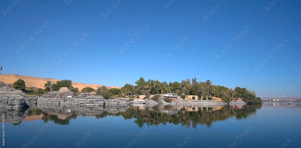 Lake Nasser with rocks, blue water 
in Aswan Governorate, Upper Egypt, near the border with Sudan.