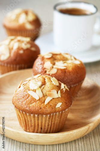 Close up of banana muffin almond in a wooden plate with a cup of coffee, in background an optional vegan dessert for a healthy low carb diet 