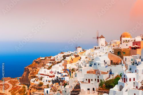 Beautiful sunset at Santorini island, Greece. Panoramic view of Oia town. Summer landscape, sea view. Famous travel destination