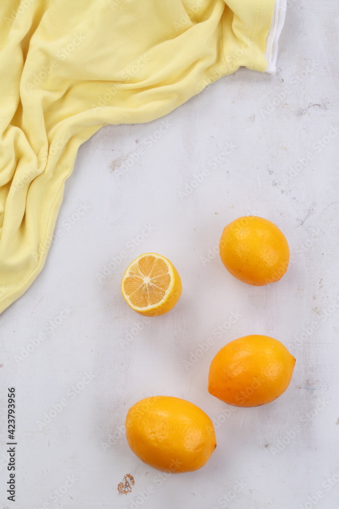 Lemons on a gray background with a yellow cloth Lemons on a gray background with a yellow cloth