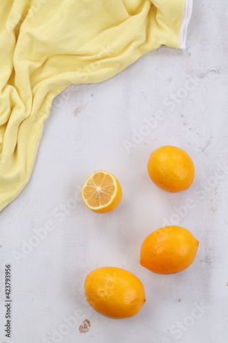 Lemons on a gray background with a yellow cloth