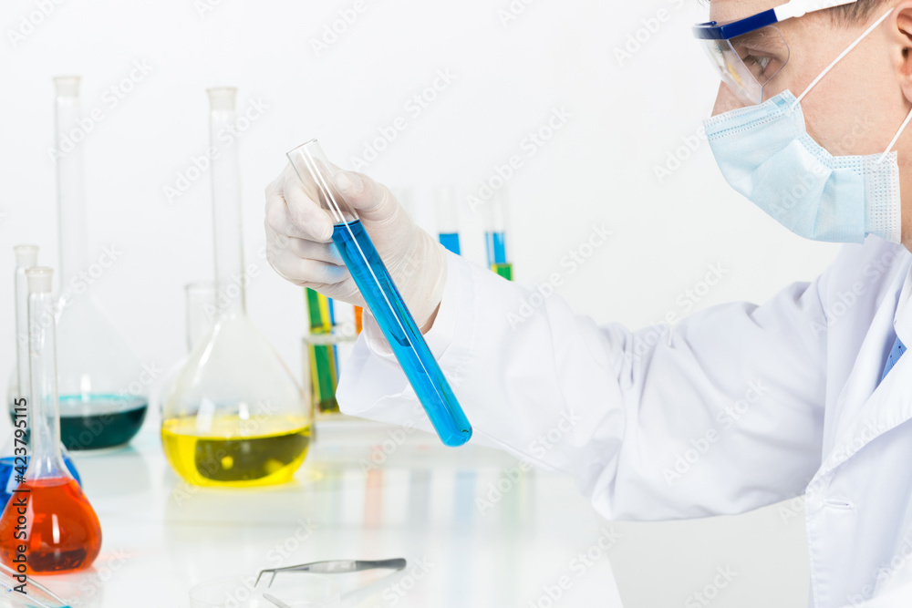 Laboratory technician in safety mask and gloves Laboratory technician in safety mask and gloves
