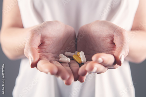closeup woman hand holding pills