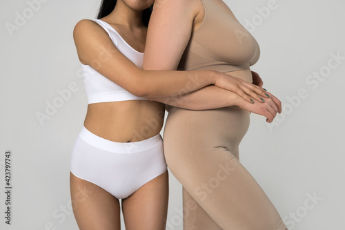 Two diverse girls with different ethnicity and type of figure