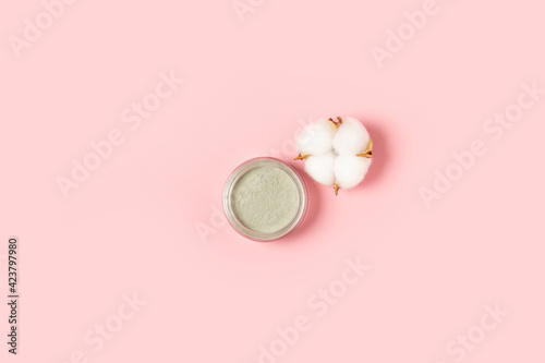 Algtnatnaya or clay face masks. Cosmetic products on a pink background. Top view, flat lay