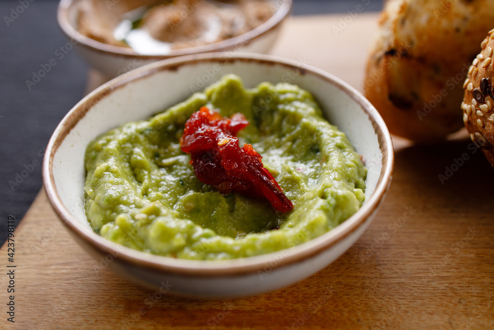 A bowl of green olive tapenade, close up A bowl of green olive tapenade, close up