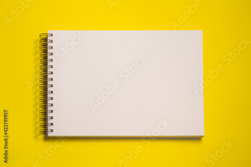 white sheets sketch pad, isolated on yellow background