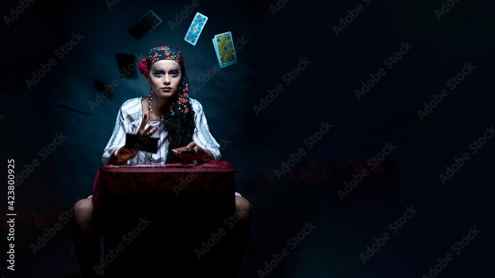 a portrait of a gypsy fortune teller throwing the tarot cards. a portrait of a gypsy fortune teller throwing the tarot cards.