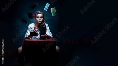 a portrait of a gypsy fortune teller throwing the tarot cards.