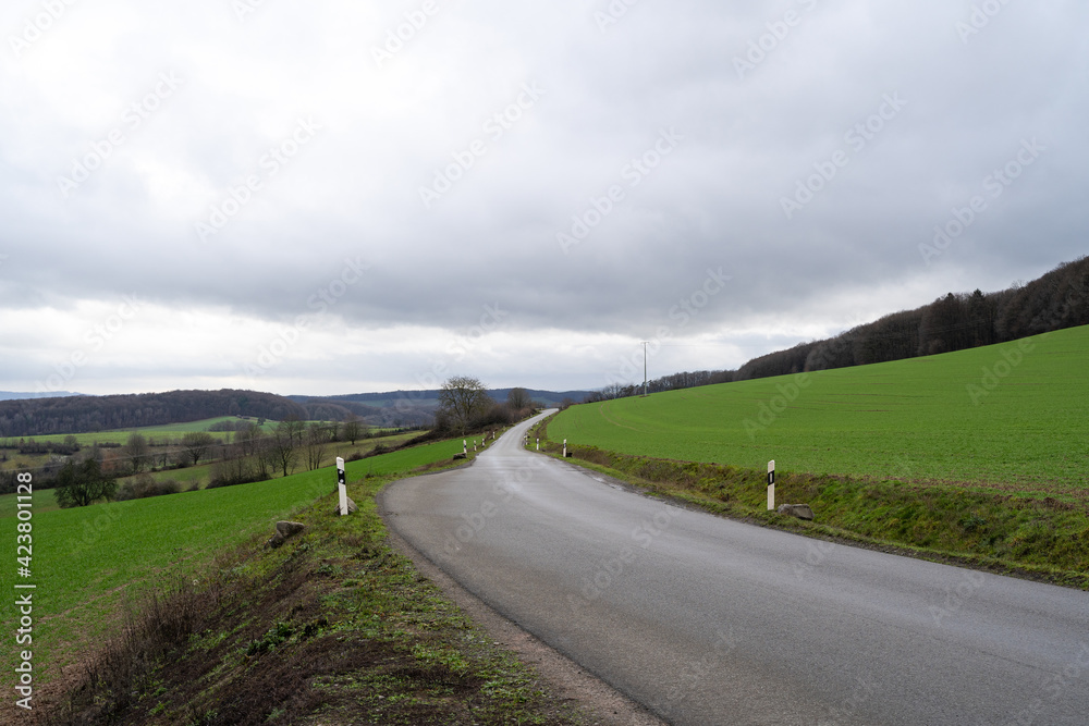 Road to the mountains with cloudy sky 