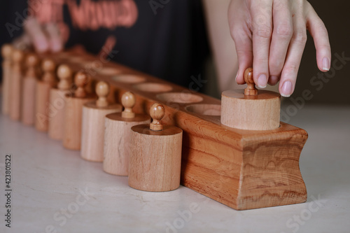 montessori sensorics cylinder block low to high and color blue box with cylinders photo