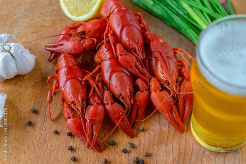 Boiled red crayfish are laid out beautifully on the table, served with herbs, a snack for beer.