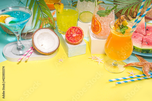 Summer holiday bar and snack concept  picnic background  Fresh watermelon slices with ice cream sticks  various alcohol cocktails and drinks  seashells and summertime accessories  flatlay top view