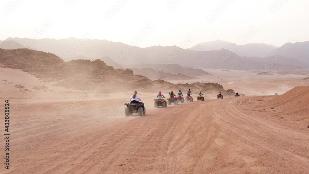 Quad bike ride through the desert near Sharm el Sheikh, Egypt.Adventures of desert off-road on ATV.Sand and Sand Borkhan. Rock and sunset. Quad Cycle Travel. Excursion with people. Quad bike ride through the desert near Sharm el Sheikh, Egypt.Adventures of desert off-road on ATV.Sand and Sand Borkhan. Rock and sunset. Quad Cycle Travel. Excursion with people.