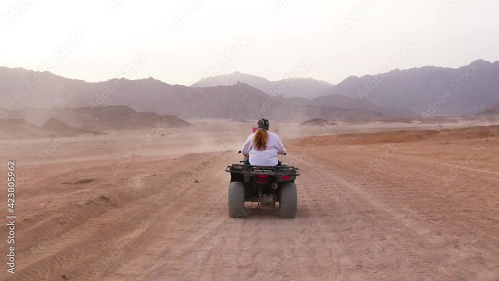 Quad bike ride through the desert near Sharm el Sheikh, Egypt.Adventures of desert off-road on ATV.Sand and Sand Borkhan. Rock and sunset. Quad Cycle Travel. Excursion with people. Quad bike ride through the desert near Sharm el Sheikh, Egypt.Adventures of desert off-road on ATV.Sand and Sand Borkhan. Rock and sunset. Quad Cycle Travel. Excursion with people.