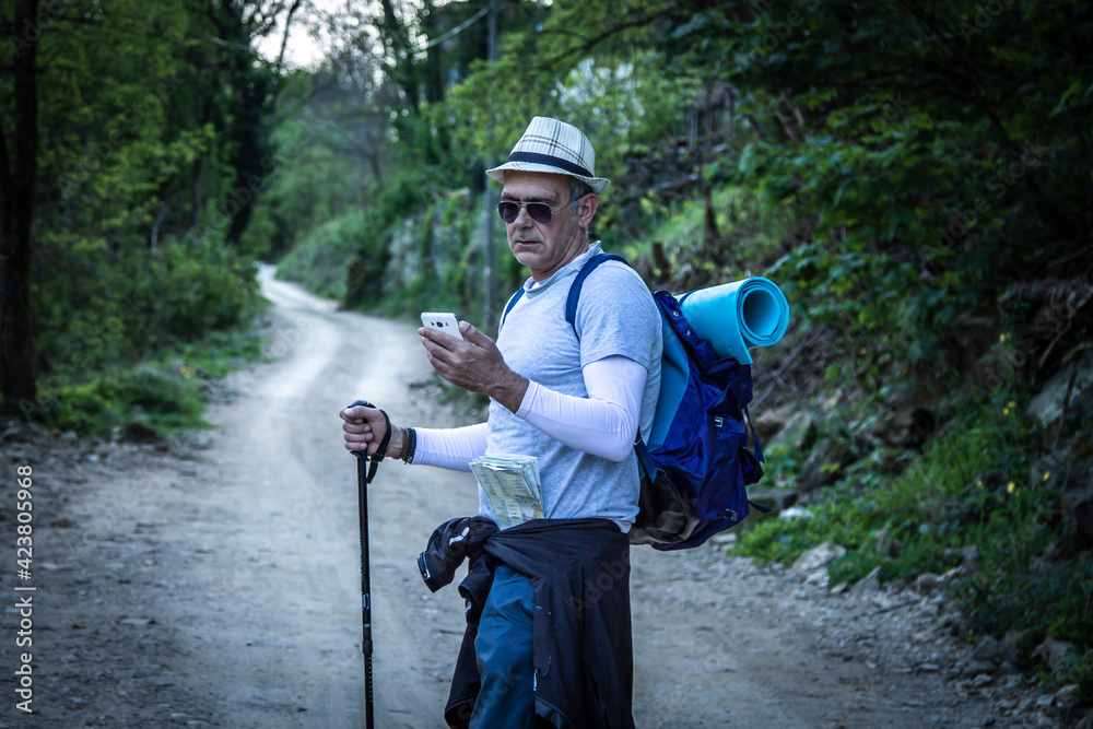 mountaineer hiking consulting the phone on the way mountaineer hiking consulting the phone on the way