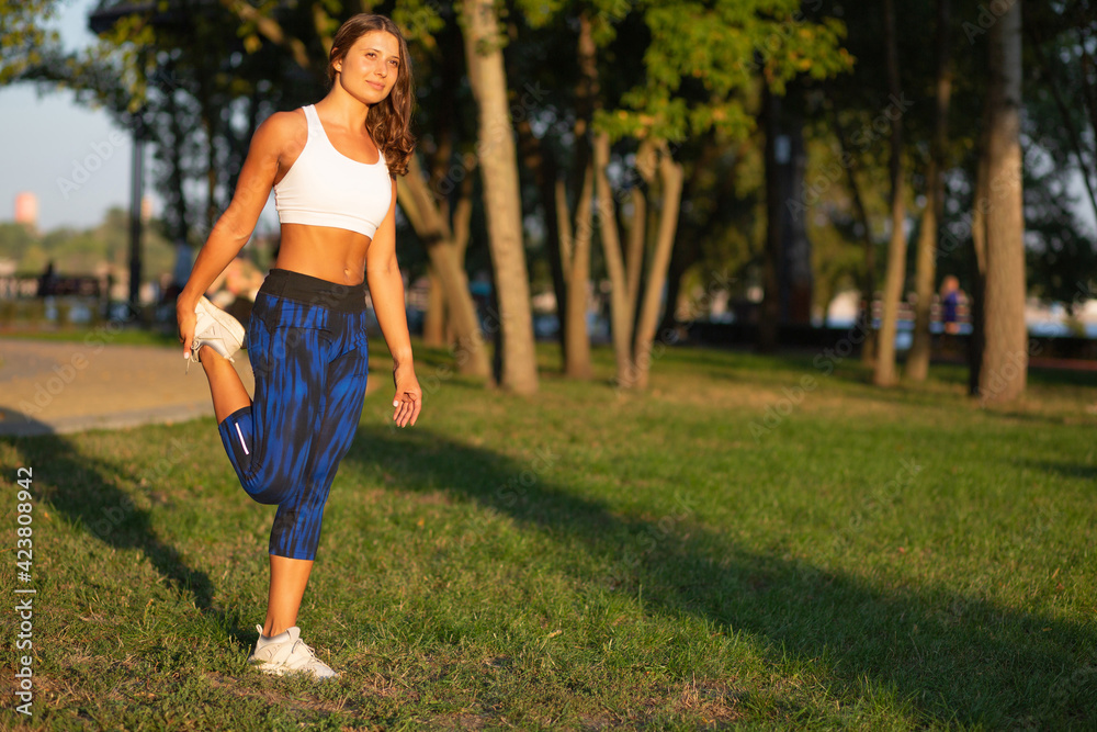 Attractive fitness woman doing stretching workout