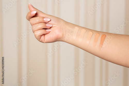 Female hand with swatches of makeup foundation