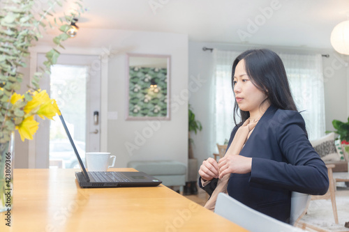 Asian female office worker doing household remote working at home