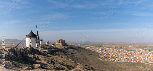 view of the windmills and castle of Consuegra in La Mancha in central Spain