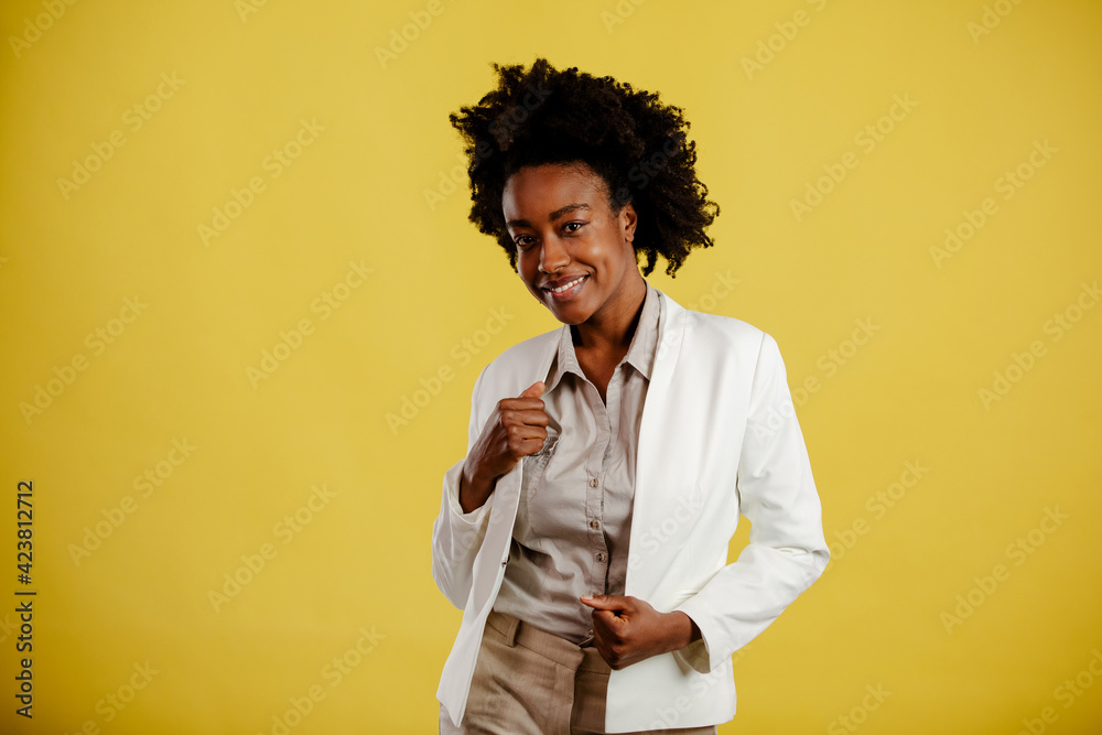 Portrait of young afro-american woman on yellow background. Portrait of young afro-american woman on yellow background.