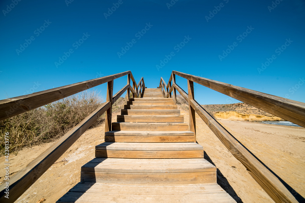 Wooden ladder going up from the beach