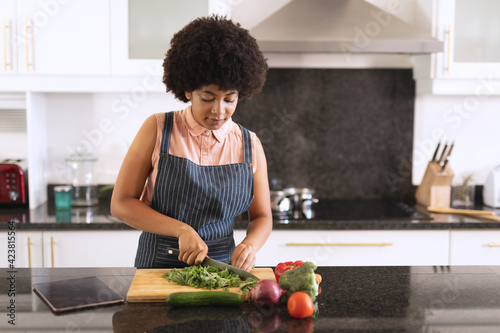 African american woman in kitchen preparing food
