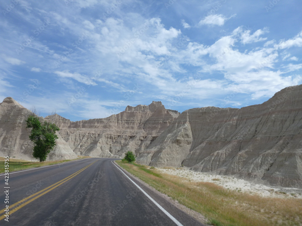 A road going through the surreal landscape and terrain at Badlands National Park in South Dakota