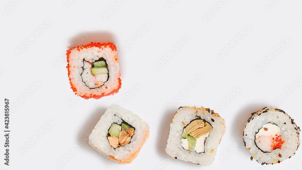 Stop motion animation with japanese food. Moving rolls on white background. Stop motion animation with japanese food. Moving rolls on white background.