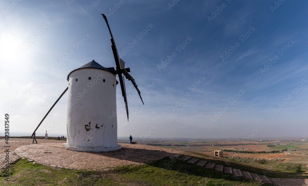 whitewashed historic windmill typical of the La Mancha region of central Spain under a blue sky whitewashed historic windmill typical of the La Mancha region of central Spain under a blue sky