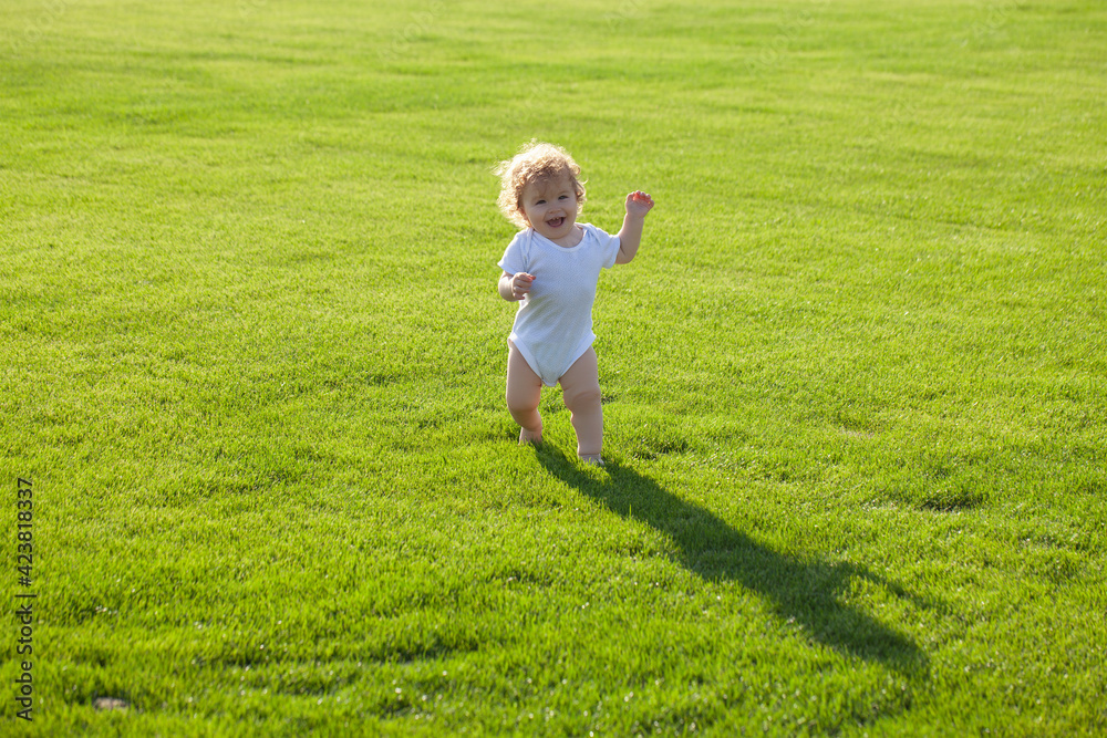 Cute funny laughing baby learning to crawl, having fun playing on the lawn watching summer in the garden. Happy childhood and child healthcare. Cute funny laughing baby learning to crawl, having fun playing on the lawn watching summer in the garden. Happy childhood and child healthcare.