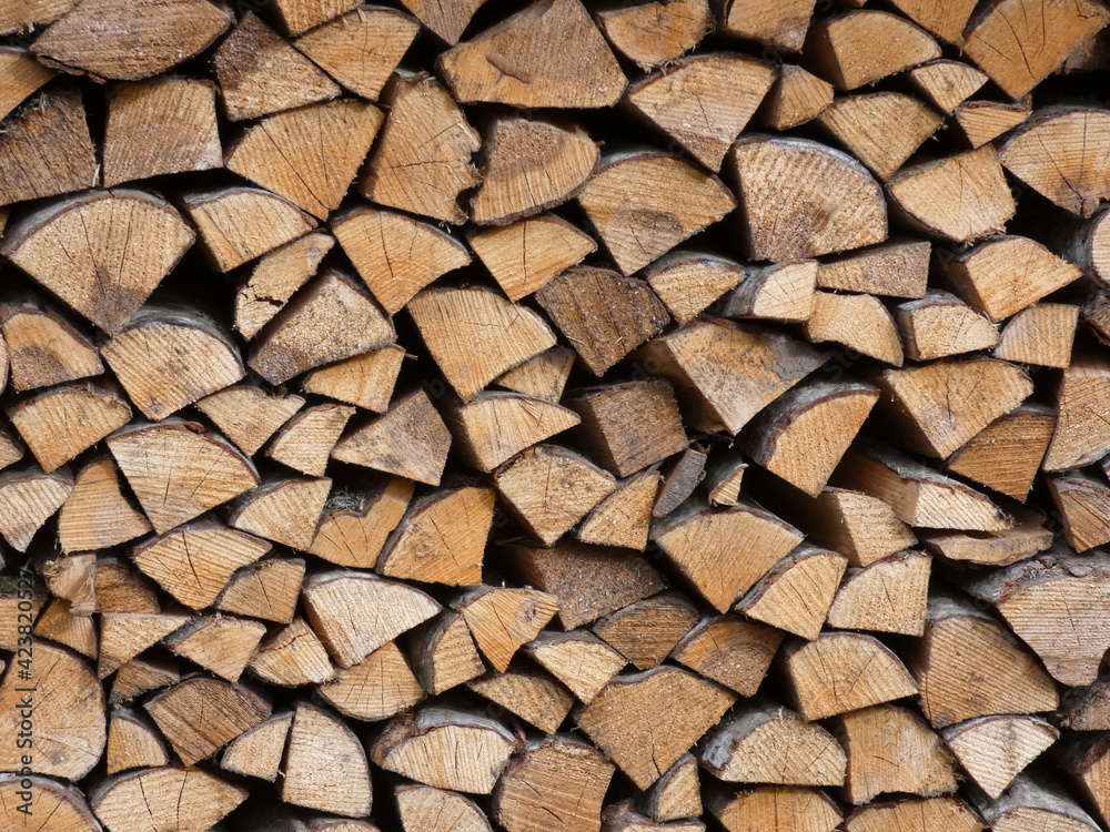 Stacked chopped firewood, natural wood texture Stacked chopped firewood, natural wood texture