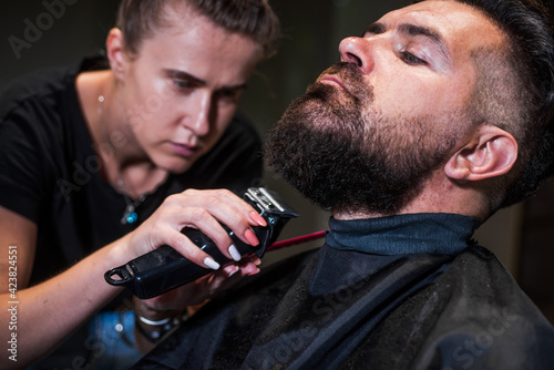 master Barber does the hairstyle and styling with electric shaver to guy, Concept Barbershop