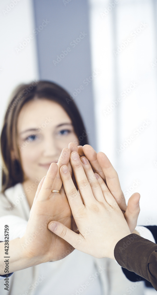 Business people group showing teamwork and joining hands or giving five in modern office. Unknown businessman and women making circle with their hands Business people group showing teamwork and joining hands or giving five in modern office. Unknown businessman and women making circle with their hands