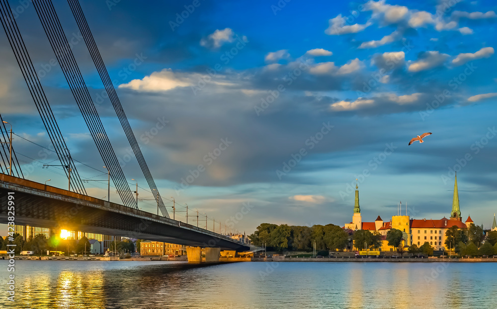 View on cable bridge and historical district of Riga - the capital of Latvia and famous Baltic city widely known among tourists due to its unique medieval and Gothic architecture