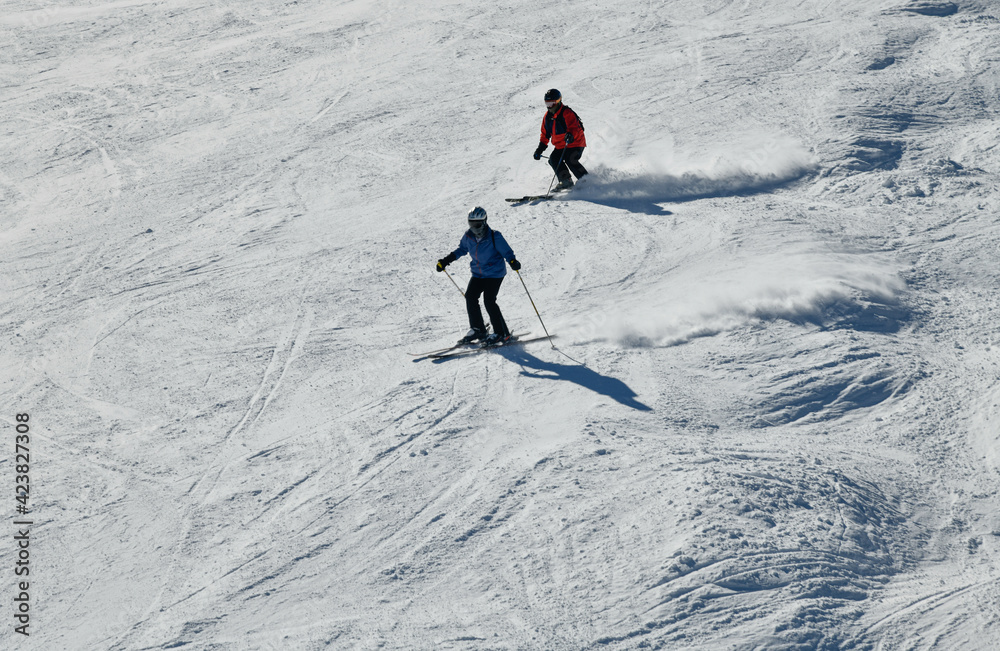 People skiing on snowy hill at Breckenridge ski resort. Extreme winter sports. Action shot. Breckenridge, CO