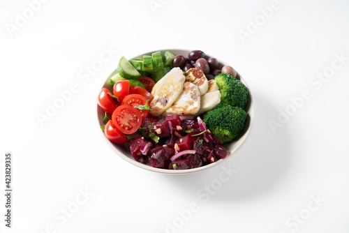Bowl with Halloumi cheese  fresh cucumbers  tomato  olives  broccoli and beets