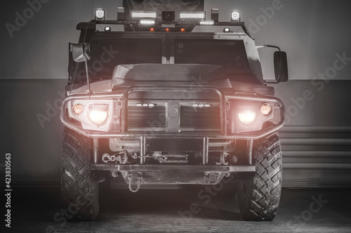 Image of a military truck with headlights and lamps on. War concept. Anti-terrorism.