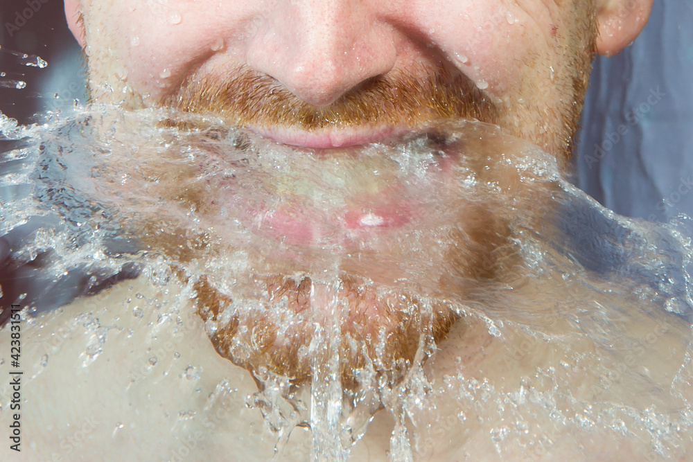 Fototapeta premium Whte man under shower water streams, dynamic face with beard