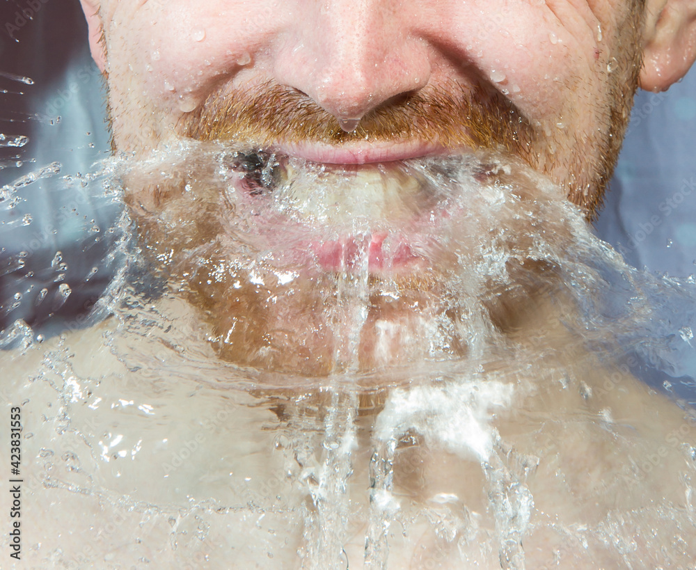 Fototapeta premium Whte man under shower water streams, dynamic face with beard