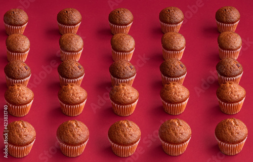 vanilla mini muffins on a red background. Place for your text. Cupcake pattern. Muffin texture. Background. High quality photo
