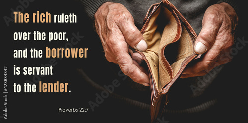 Christian bible verses proverbs 22: 7, elderly senior holding an empty wallet in old hands photo